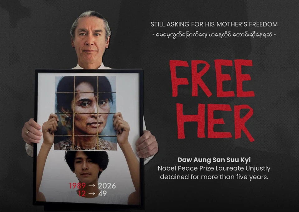 FREE HER postcard front: Kim Aris holding a photograph of his mother, Daw Aung San Suu Kyi.