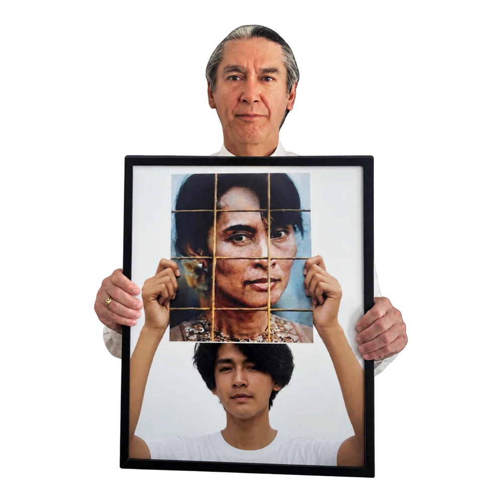 Kim Aris holds a framed photograph of his younger self holding a portrait of his mother, Daw Aung San Suu Kyi.